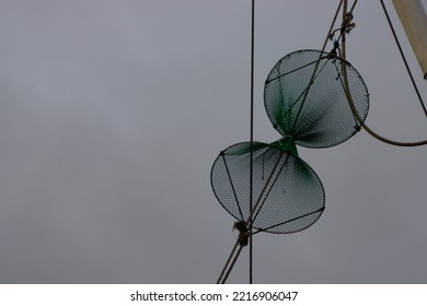 Close Up Of Fishing Net Hanging In The Rigging Of A Fish Trawler