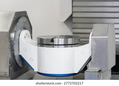 Close up of five axis turntable of CNC machine in factory workshop