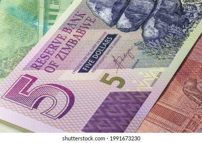 Close Up To Five Dollars Of The Republic Of Zimbabwe. Paper Banknotes Of The African Country. Detailed Capture Of The Front Art Design. Detailed Money Background Wallpaper. Currency Bank Note