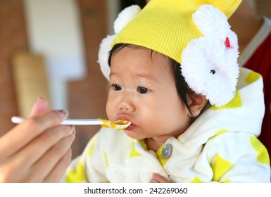 Close Up Five Month Old South East Asian Thai Baby Girl Being Spoon Fed