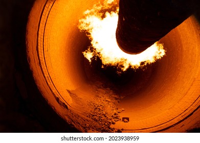 Close up of flame in rotary kiln during heating mode in cement plant