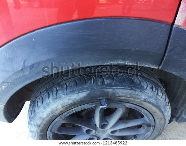 Close up flat\
tire damaged by a piece of\
metal