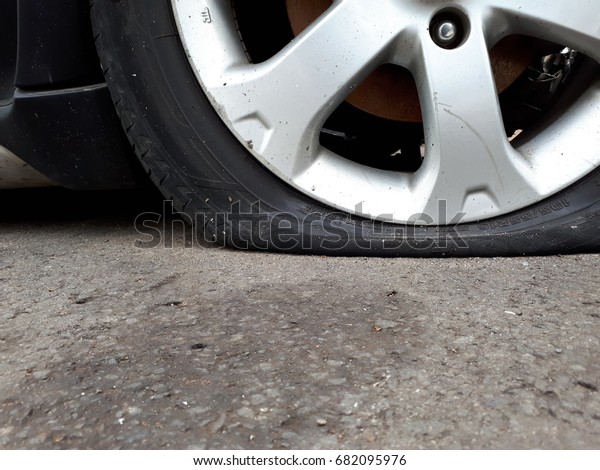 close up of Flat Tire\
on the asphalt road