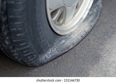 Close Up Of A Flat Tire On Car