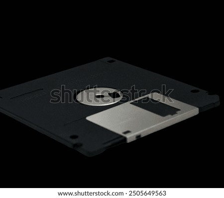 close up of a floppy disk that was once popular for storing data on a computer with a black background