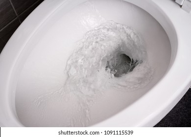 Close Up Flushing Water In Toilet Bowl.