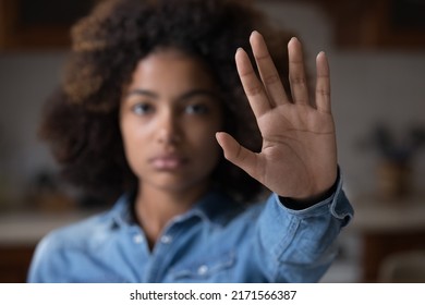 Close up focus African woman show palm hand opposes racial or gender discrimination, make stop gesture, sign of protest, female against domestic violence, abortion, bullying at school, say no concept