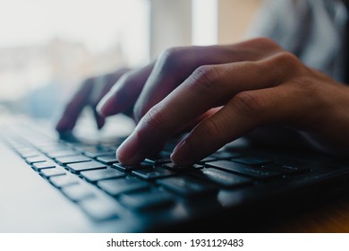 Close focus of man's hands typing. Man working at home office hand on keyboard close up. Selective focus.