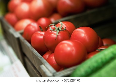 Close Up Focus On Fresh Ripe Tomato Vegetables In Box At Grocery Food Store.Buy Natural Healthy Foods Ingredients For Healthy Eating.Tomatoes On Fridge Shelf In Grocery Store Aisle.