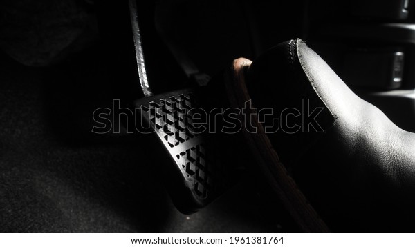 Close up the foot pressing foot pedal of a car to
drive. Accelerator and brake pedal in a car. Driver driving the car
by pushing accelerator and break pedals of the car. inside vehicle.
control pedal.