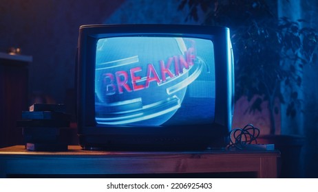 Close Up Footage of a Dated TV Screen. Breaking News Report Starting. Intro with Word Breaking Revolving Around Digital Earth on Vintage Display. Nostalgic Retro Nineties Technology Concept. - Shutterstock ID 2206925403