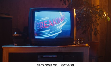 Close Up Footage Of A Dated TV Set Screen. Breaking News Report Starting. Intro With Word Breaking Revolving Around Digital Earth On Vintage Display. Nostalgic Retro Nineties Technology Concept.