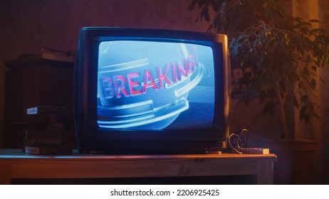 Close Up Footage Of A Dated TV Set Screen: Breaking News Report. Intro With Word Breaking Revolving Around Digital Earth On Vintage Display. Nostalgic Retro Nineties Technology Concept.