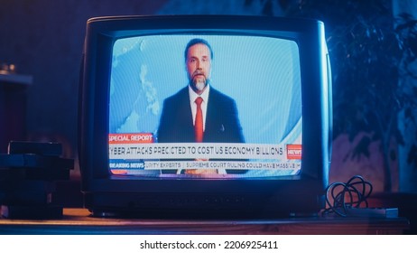 Close Up Footage Of An Old TV Set Screen With Breaking News Report. Handsome Middle Aged Anchorman Reads Important News On Live Television Broadcast. Nostalgic Retro Nineties Technology Concept.