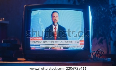 Close Up Footage of an old TV Set Screen with Breaking News Report. Handsome Middle Aged Anchorman Reads Important News on Live Television Broadcast. Nostalgic Retro Nineties Technology Concept.