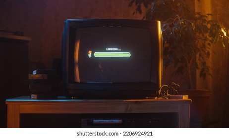 Close Up Footage of a Retro TV Set Screen with an Eight Bit Eighties Inspired Console Arcade Video Game. Quest Loading, Player Waiting to Start New Harder Level. Green Progress Bar Moving. - Shutterstock ID 2206924921