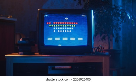 Close Up Footage of a Retro TV Set Screen with an 8 Bit 2D Eighties Inspired Console Arcade Video Game. Nostalgic Shooter Game, Player Battle with Swarm of Aliens and Wins the Level. - Shutterstock ID 2206925405