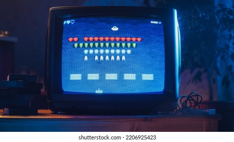 Close Up Footage of a Retro TV Set Screen with an 8 Bit 2D Eighties Inspired Console Arcade Video Game. Nostalgic Shooter Game, Player Battle with Swarm of Aliens and Wins the Hardest Level. - Powered by Shutterstock