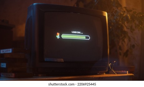 Close Up Footage of a Retro TV Set Screen with an Eight Bit Eighties Inspired Console Arcade Video Game. Quest Loading, Player Waiting to Start a New Harder Level. Green Progress Bar Moving. - Powered by Shutterstock - Get 15% off with code: PIKWIZARD15