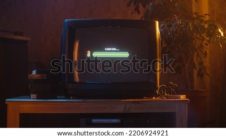 Close Up Footage of a Retro TV Set Screen with an Eight Bit Eighties Inspired Console Arcade Video Game. Quest Loading, Player Waiting to Start New Harder Level. Green Progress Bar Moving. Stock foto © 