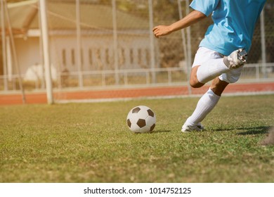 Close Up Football Player Kick Soccer In The Stadium