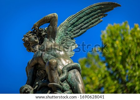 Close up of the Fountain of the Fallen Angel or Fuente del Angel Caido in the Buen Retiro Park in Madrid, Spain inaugurated in 1885