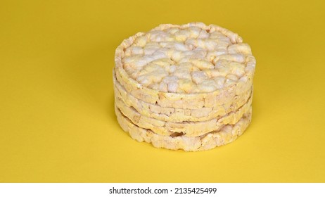 Close up of four round crunchy tasty corn waffles lying on a stack isolated on yellow background - Powered by Shutterstock