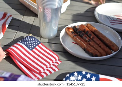 Close Up Of A Fourth Of July Bbq Table With Flags And Hot Dogs