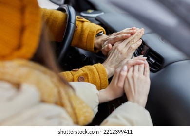 Close Up Of Freezing Young Couple Trying To Warm Hands On Car Heater, Travelling In Winter