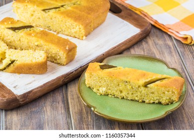 Close Up Of Fresh Baked Cut Hatch Chili Pepper Cornbread On A Cutting Board.