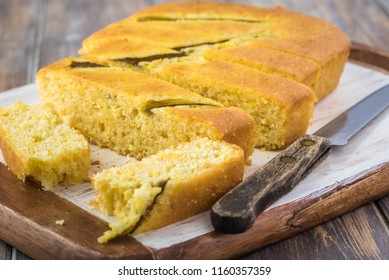 Close Up Of Fresh Baked Cut Hatch Chili Pepper Cornbread On A Cutting Board.