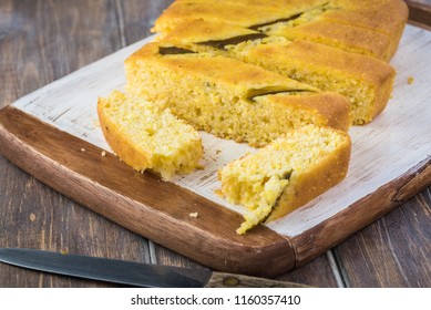 Close Up Of Fresh Baked Cut Hatch Chili Pepper Cornbread On A Cutting Board.