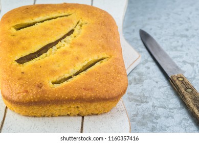 Close Up Of Fresh Baked Hatch Chili Pepper Cornbread On A Cutting Board.