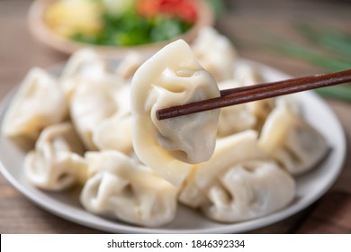 Close up fresh boiled dumplings . Chinese food on rustic old vintage wooden background.