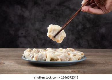 Close up fresh boiled dumplings . Chinese food on rustic old vintage wooden background.