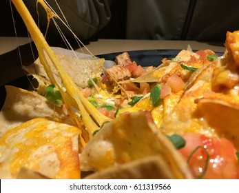 Close Up Of Fresh Cheesy Nachos Being Stretched