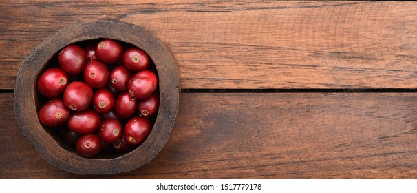 close up of fresh coffee beans on wooden background