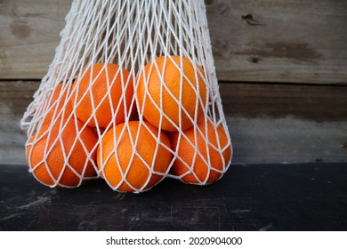 Close Up Of Fresh Oranges Fruit In French String Cotton Shopping Market Bag