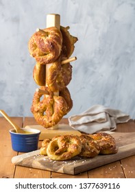 Close Up Of Freshly Made Baked Pretzels With Course Salt And A Side Of Honey Mustard Dip Ready For Eating.