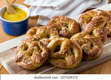 Close Up Of Freshly Made Baked Pretzels With Course Salt And A Side Of Honey Mustard Dip Ready For Eating.