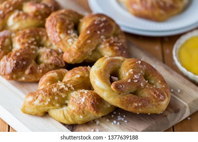 Close Up Of Freshly Made Baked Pretzels With Course Salt And A Side Of Honey Mustard Dip Ready For Eating.