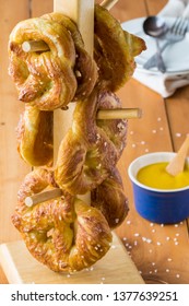 Close Up Of Freshly Made Baked Pretzels With Course Salt And A Side Of Honey Mustard Dip Ready For Eating.