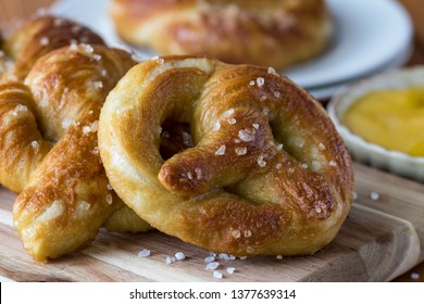 Close Up Of Freshly Made Baked Pretzels With Course Salt And A Side Of Honey Mustard Dip Ready For Eating.