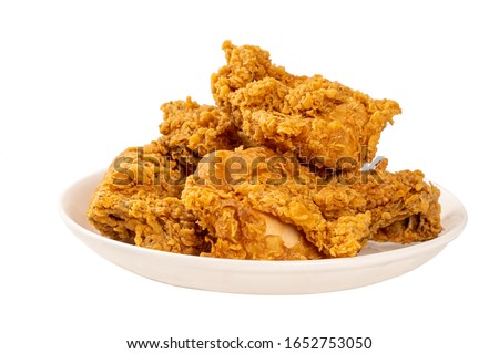 Close Up Fried Chickens on white Plate Isolated on table. Look Yummy and Yellow Gold Color.