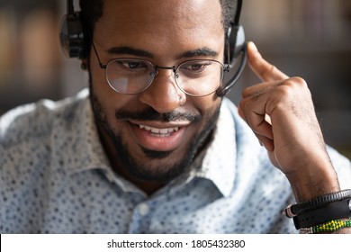 Close Up Friendly African American Man Wearing Headset Speaking In Microphone, Smiling Call Center Customer Service Operator Wearing Glasses Consulting Client, Mentor Coach Leading Online Lesson