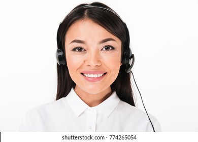 Close Up Of A Friendly Asian Woman In White Shirt Wearing Headset With Microphone Isolated Over White Background