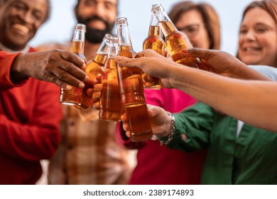 close up of friends toasting with beer in hand. - Powered by Shutterstock