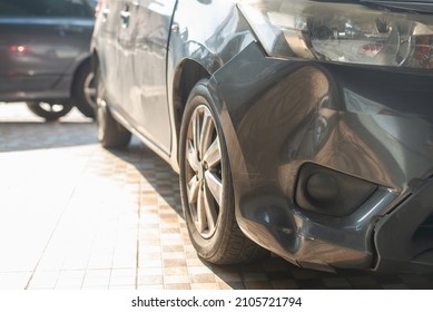 Close Up Of The Front Bumper Dent Of A Grey Car In Preparation Of Repair Work,Make The Surface Of The Car Smooth ,preparing For Painting At Station Service.