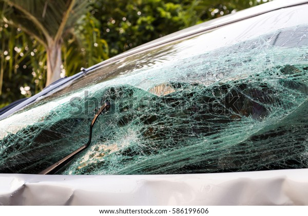 Close the front glass from the\
demolished car broken in an accident with another\
vehicle.