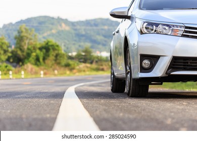 Close up front of new silver car parking on the asphalt road - Shutterstock ID 285024590